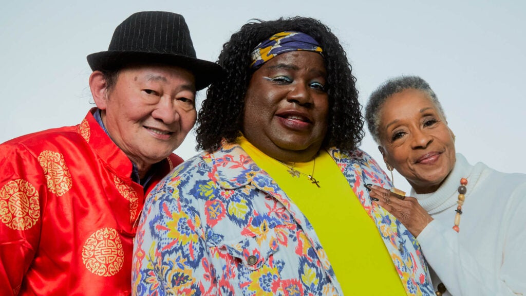 Group of three seniors smiling at camera