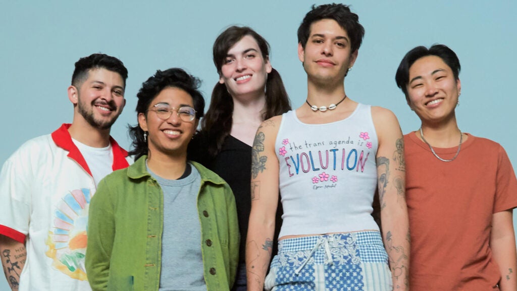 Group of queer youth standing together and smiling