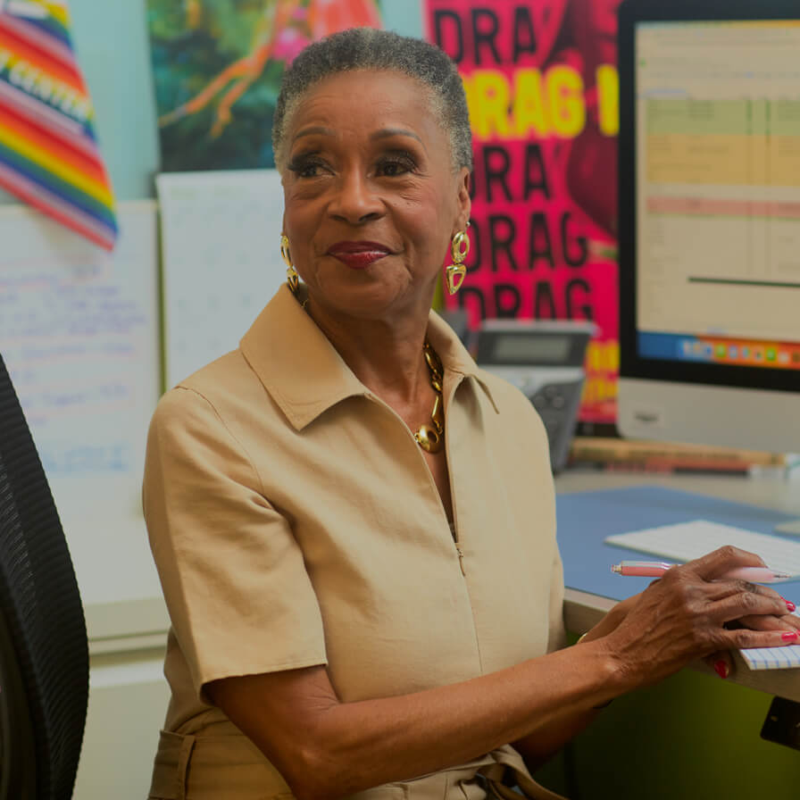 Senior Black woman sitting at desk